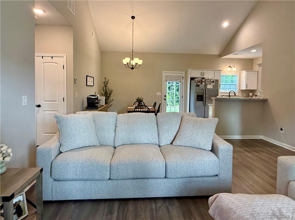 1776 Pleasant Grove Road Temple, GA 30179 - Photo 7 of 45 a living room with furniture kitchen view and a wooden floor