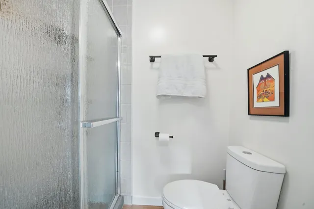 a white toilet sitting next to a bathroom sink