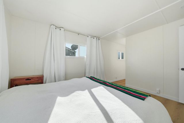 a bedroom with a bed and a mirror