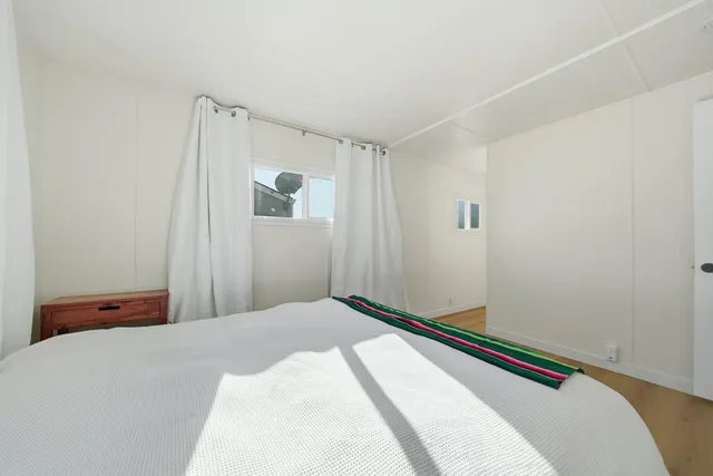 a bedroom with a bed and a mirror