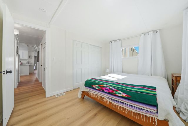 a room with a bed and wooden floor