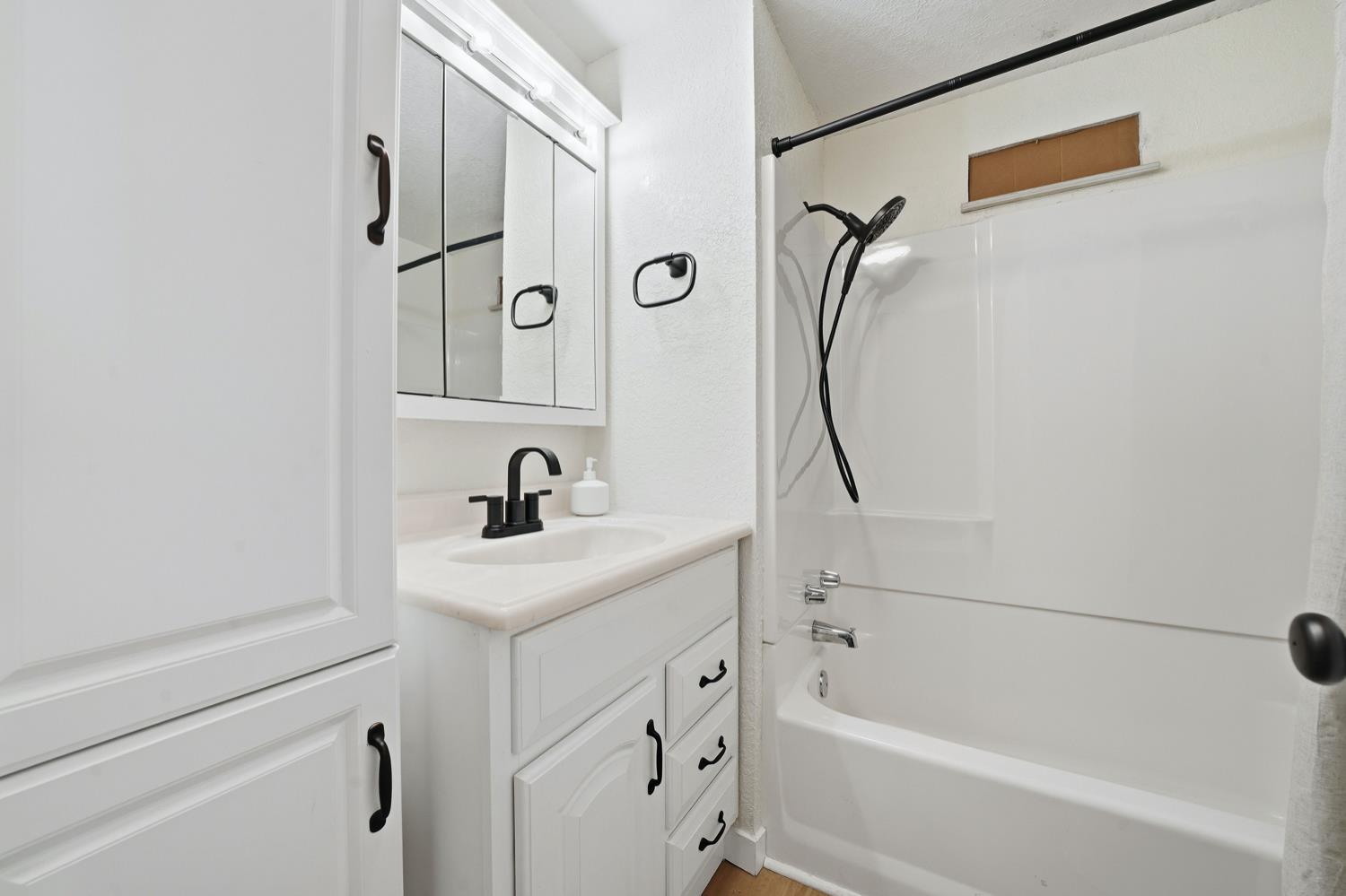 59 Oneida Street Oakley, CA 94561 - Photo 23 of 45 a bathroom with a granite countertop sink a mirror and a bathtub