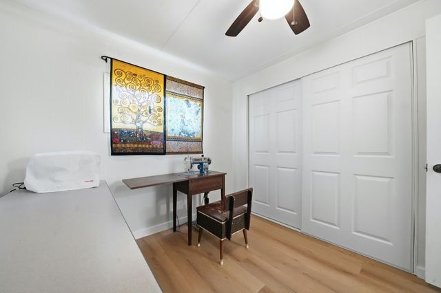 a workspace with wooden floor and a window