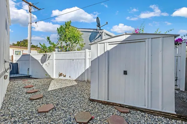 a view of a house with a wooden fence