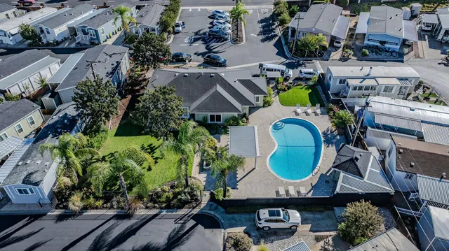 an aerial view of a house with garden space and swimming pool
