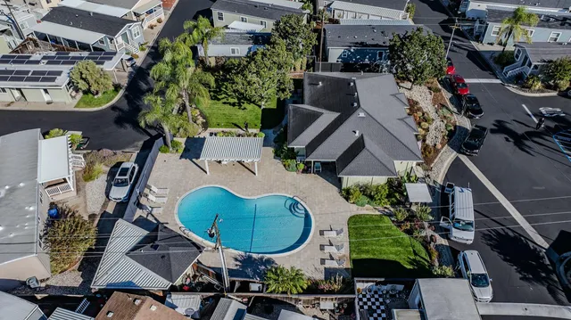 an aerial view of a house with garden space and swimming pool