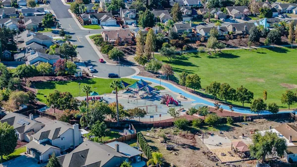 an aerial view of a house with a yard