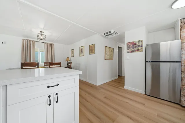 a room with a refrigerator and a sink