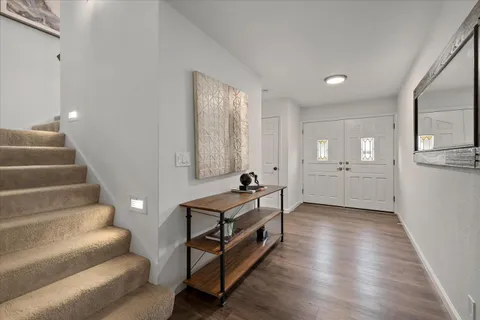 a view of a livingroom with furniture and stairs
