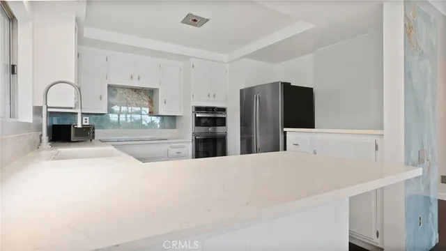 a kitchen with a stove a sink and a microwave