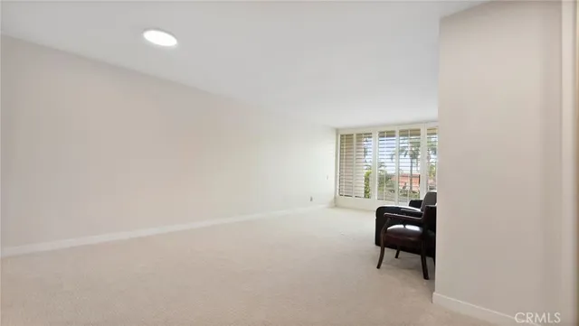 a living room with furniture and large windows