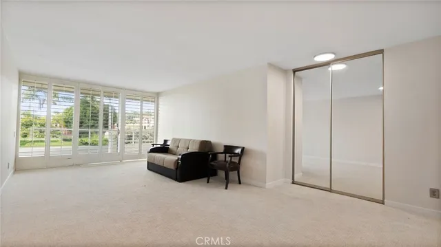 a living room with a flat screen tv and a wall painting