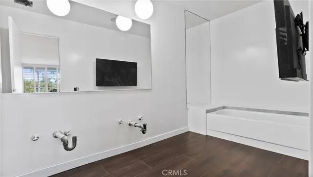 a bathroom with a toilet and a mirror