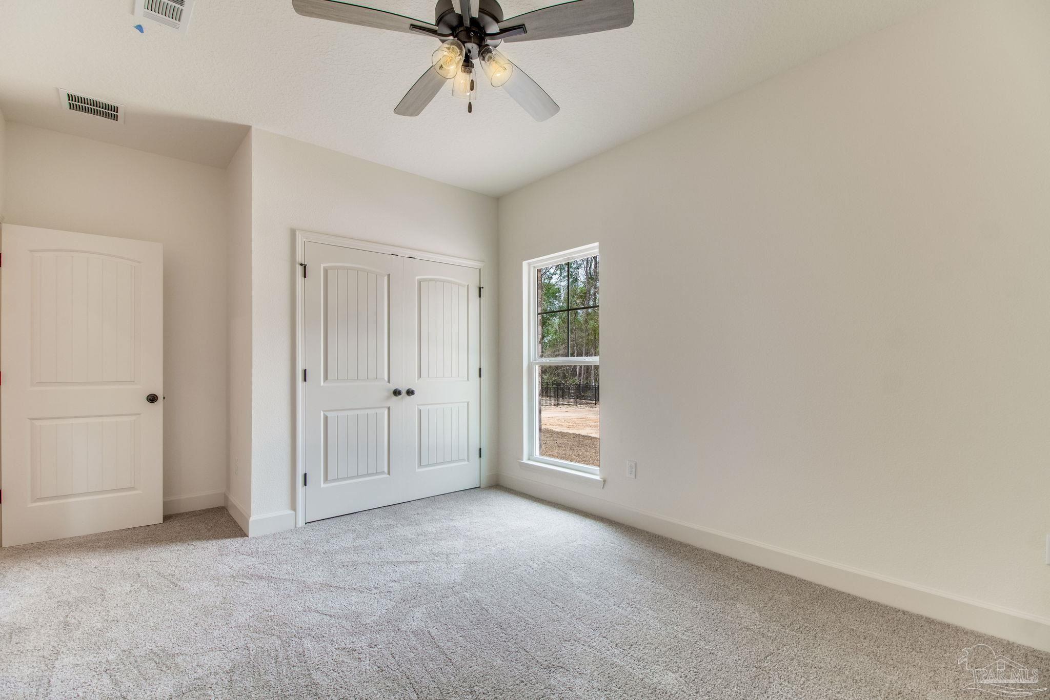 4310 Watkins Street Pace, FL 32571 - Photo 48 of 58 a view of a livingroom with a ceiling fan and window