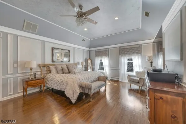 a bedroom with furniture and a flat screen tv