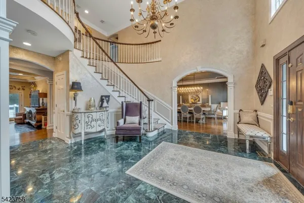 a living room with furniture and a chandelier