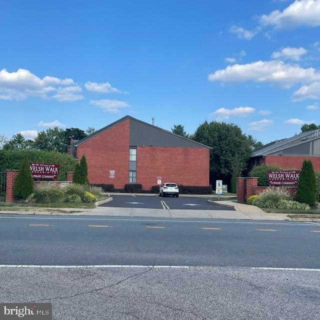 2015 Welsh Road, Unit A24 Philadelphia, PA 19115 - Photo 27 of 29 a front view of a house with a yard and garage