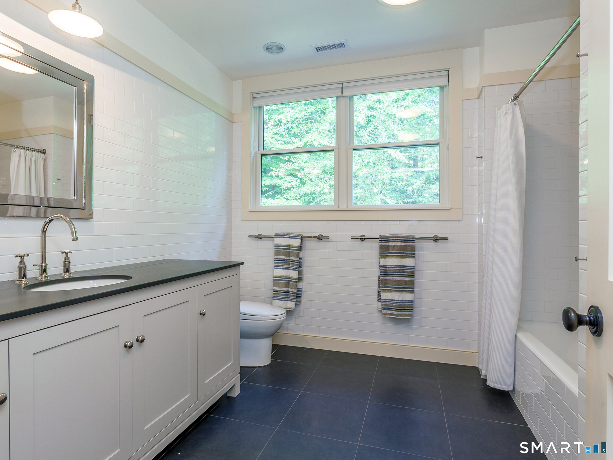 68 Hopkins Road Warren, CT 06777 - Photo 21 of 30 a bathroom with a granite countertop sink toilet a large mirror a bathtub and window