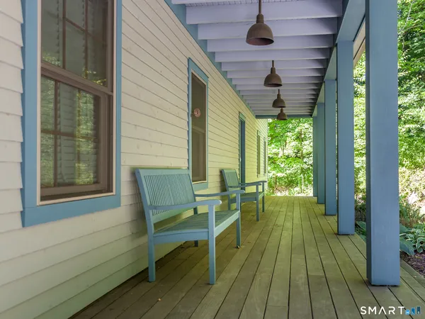 a balcony with chairs and wooden floor
