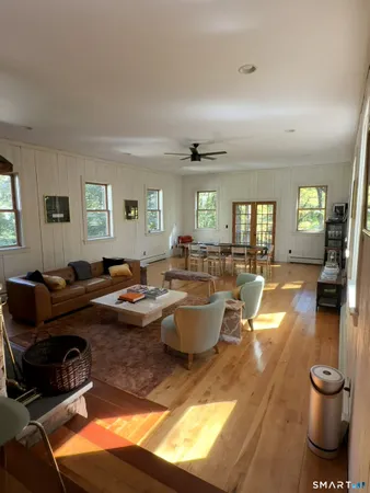 a living room with furniture a rug and a window