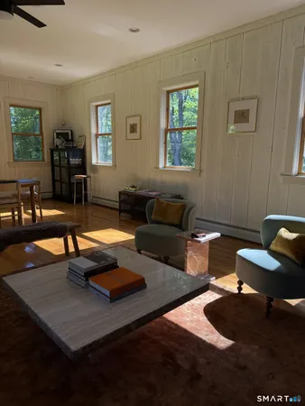 a living room with furniture rug and window