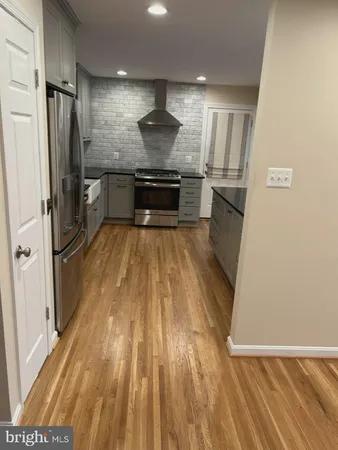 a view of kitchen with sink and refrigerator