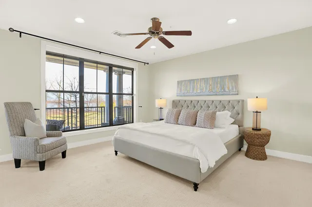 a spacious bedroom with a bed and a couch