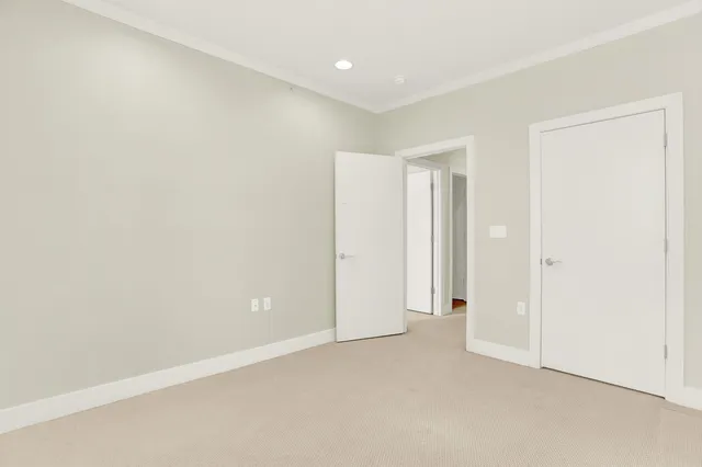a view of hallway with walk in closet and livingroom