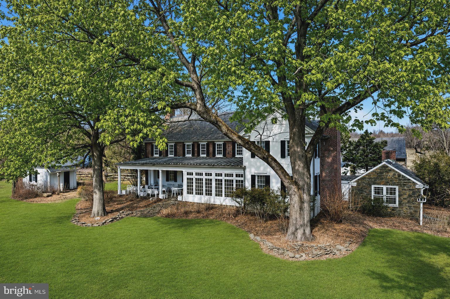6693 Groveland Road Pipersville, PA 18947 - Photo 1 of 1 a front view of a house with a garden