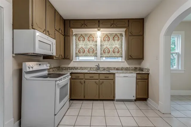 a kitchen with a stove top oven sink and cabinets