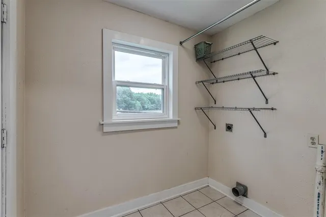 a view of a room with rack on the wall and a window