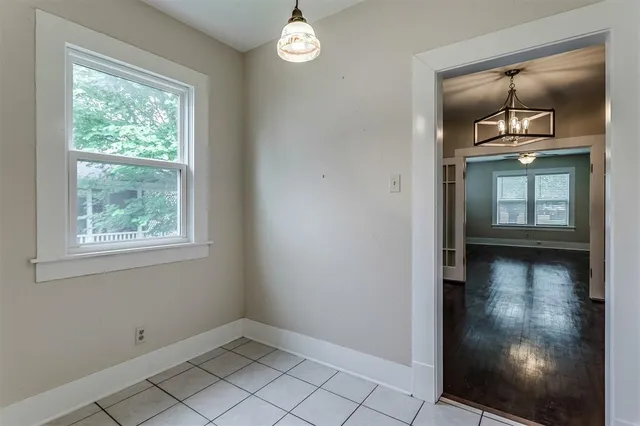 an empty room with windows and cabinet