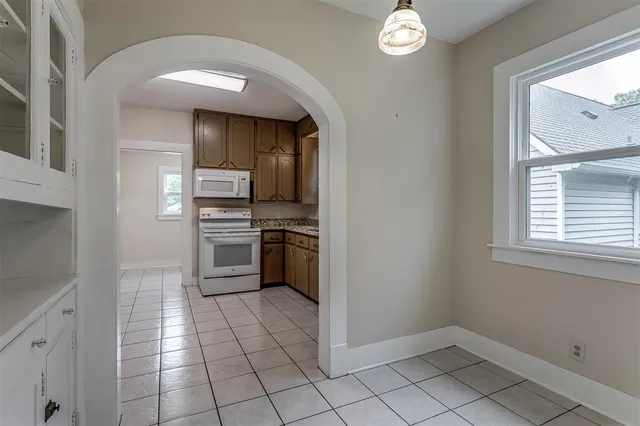 a kitchen with cabinets and steel appliances