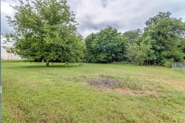 a view of outdoor space with a garden and trees