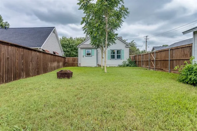 a backyard of a house with table and chairs