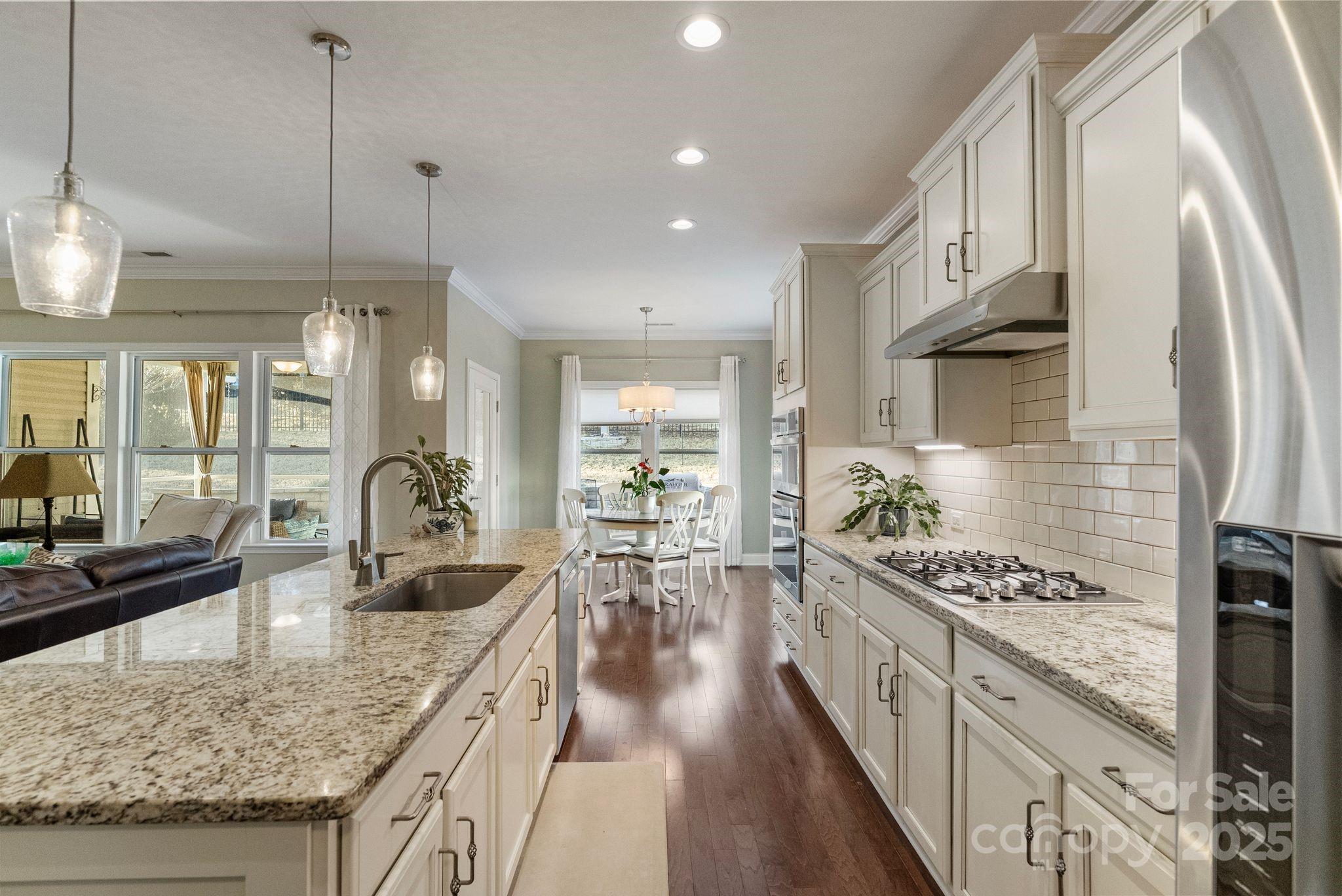2304 Celandine Way Tega Cay, SC 29708 - Photo 13 of 47 a kitchen with stainless steel appliances granite countertop a sink stove and refrigerator