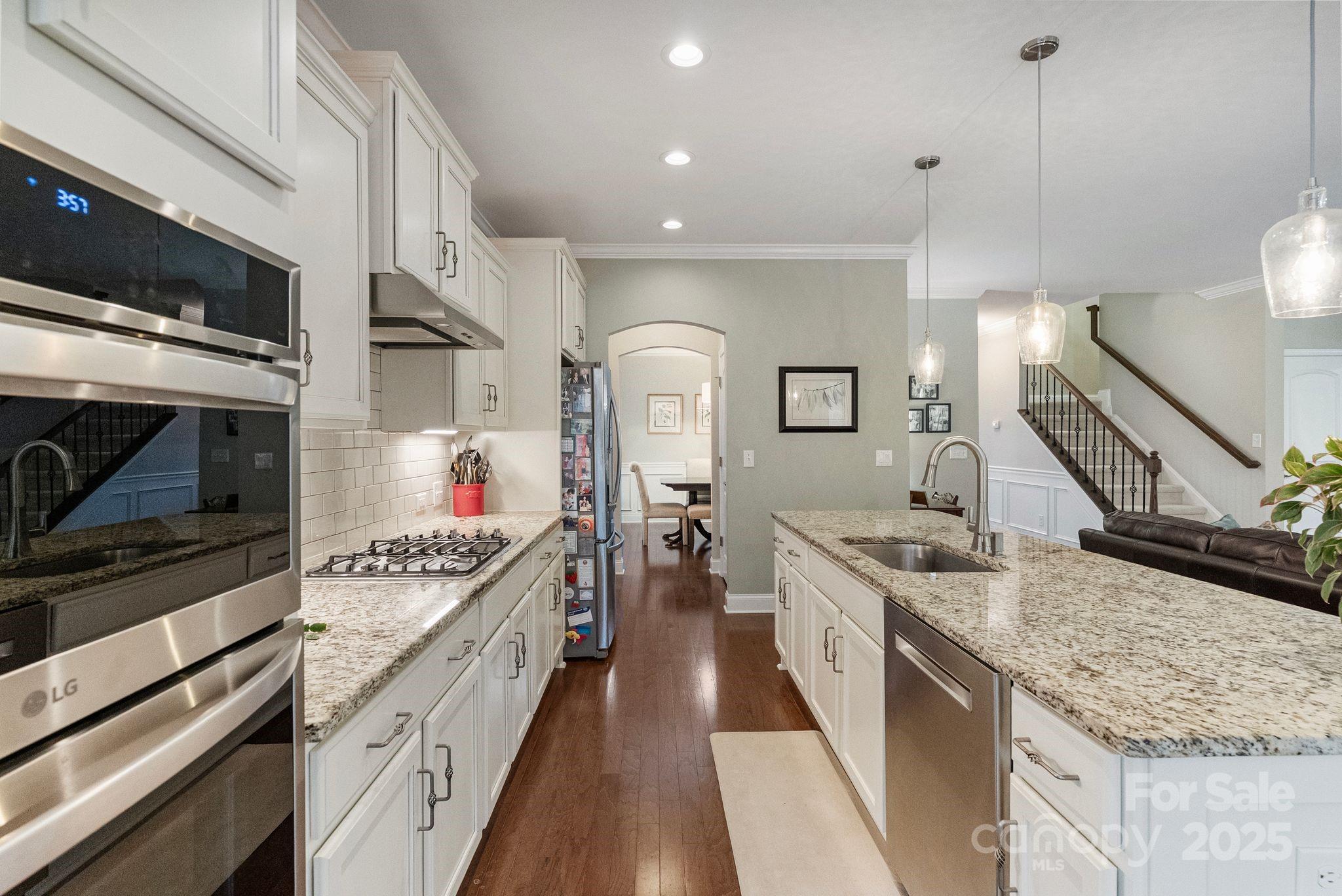 2304 Celandine Way Tega Cay, SC 29708 - Photo 15 of 47 a kitchen with stainless steel appliances granite countertop a stove and a sink