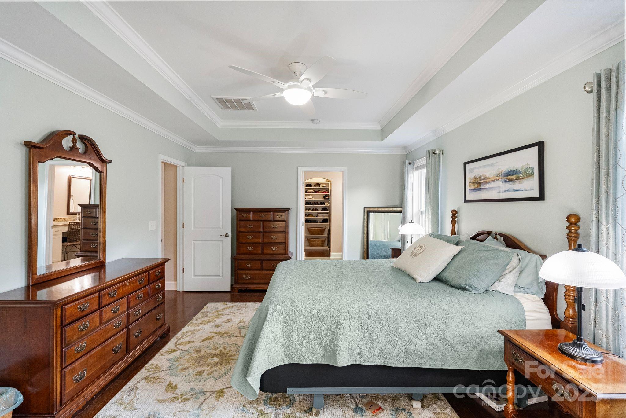 2304 Celandine Way Tega Cay, SC 29708 - Photo 19 of 47 a bedroom with a bed and dresser with mirror