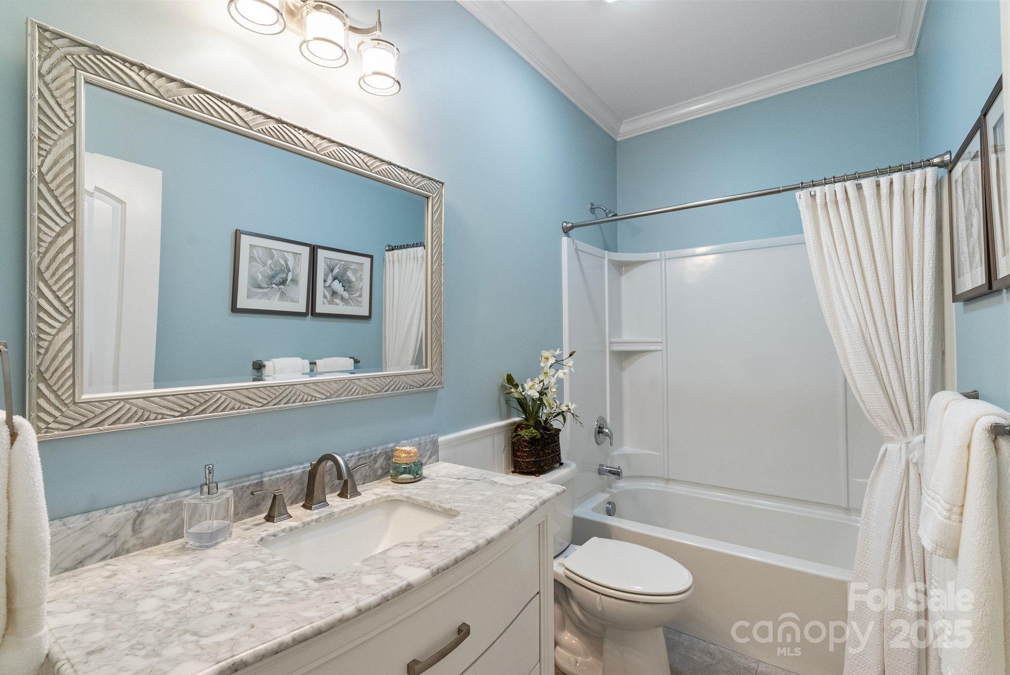 2304 Celandine Way Tega Cay, SC 29708 - Photo 27 of 47 a bathroom with a granite countertop sink toilet and shower