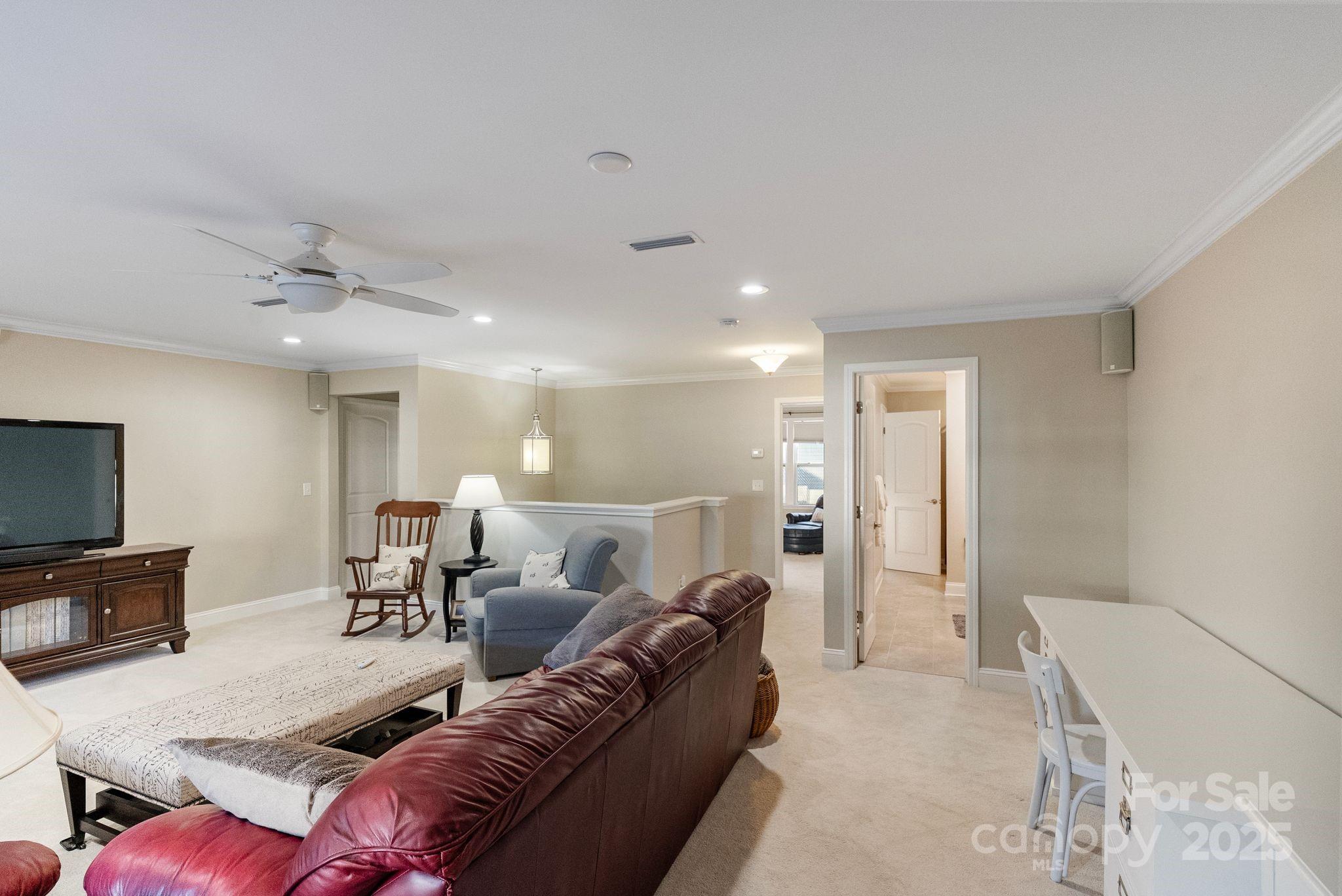 2304 Celandine Way Tega Cay, SC 29708 - Photo 30 of 47 a living room with furniture and a flat screen tv