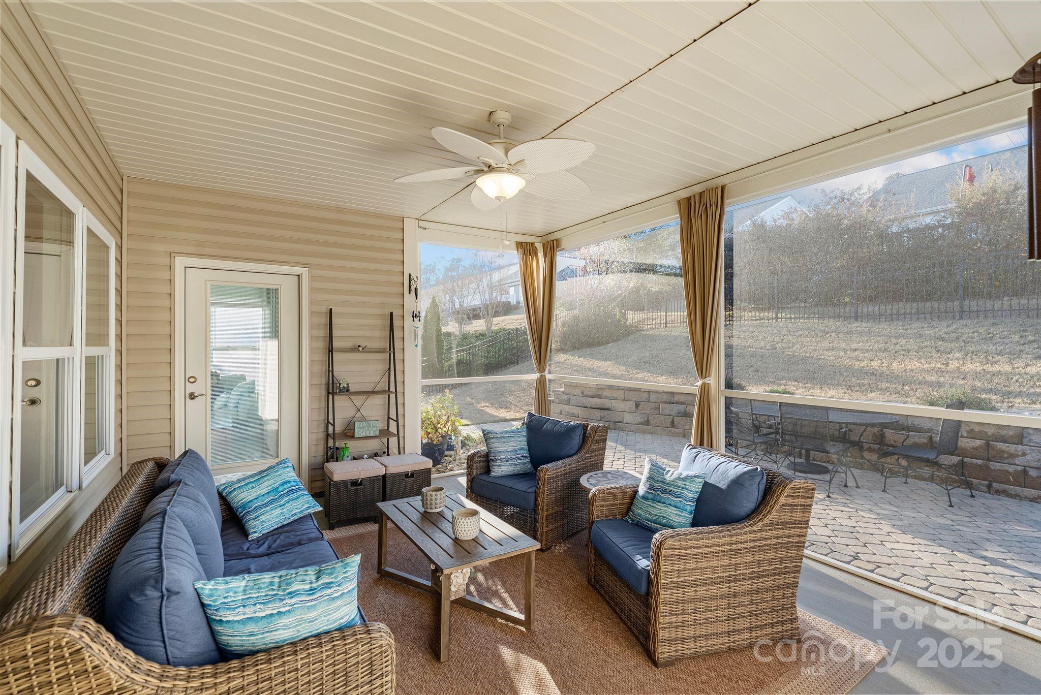 2304 Celandine Way Tega Cay, SC 29708 - Photo 37 of 47 a living room with furniture and a floor to ceiling window