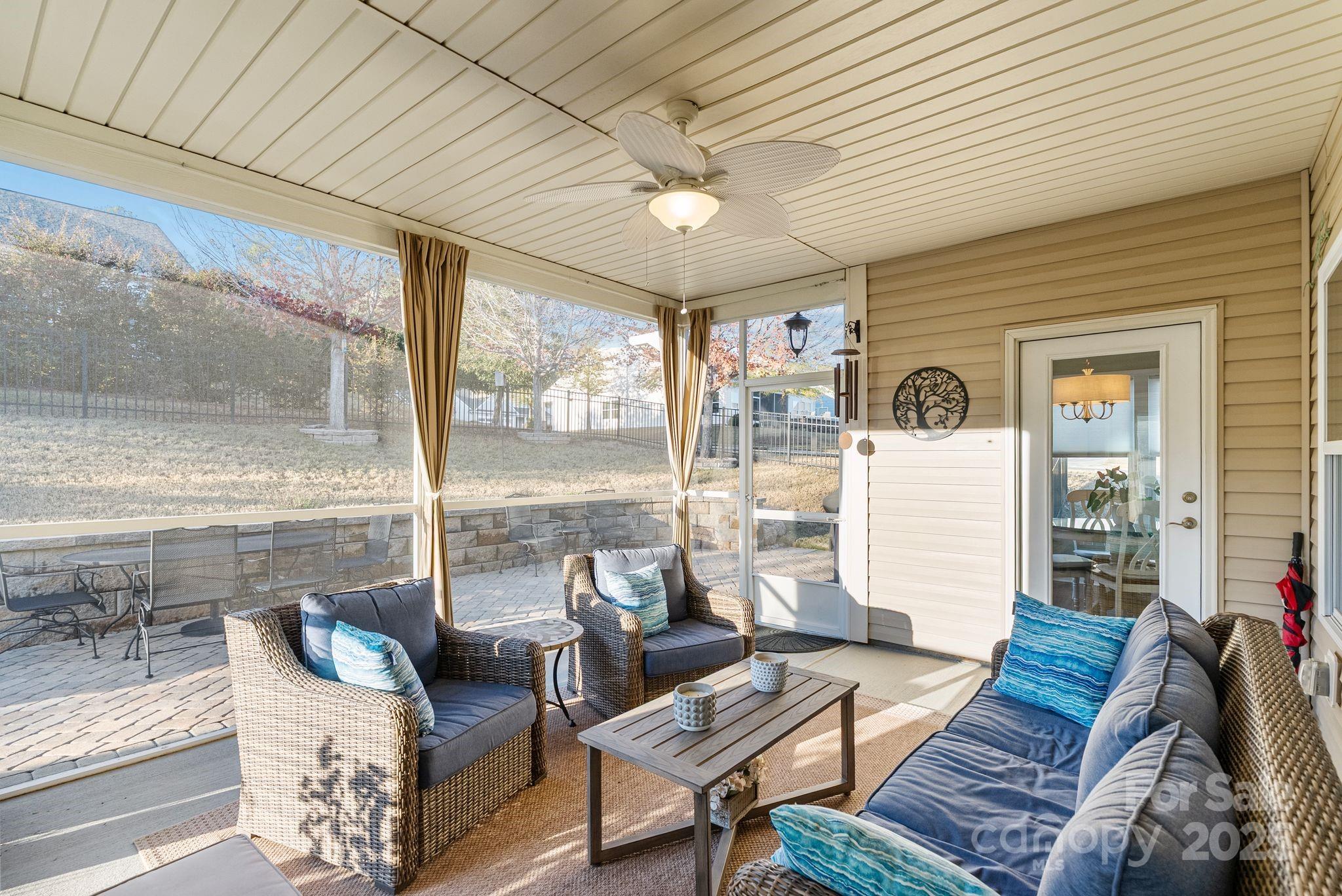 2304 Celandine Way Tega Cay, SC 29708 - Photo 38 of 47 a living room with furniture and a floor to ceiling window
