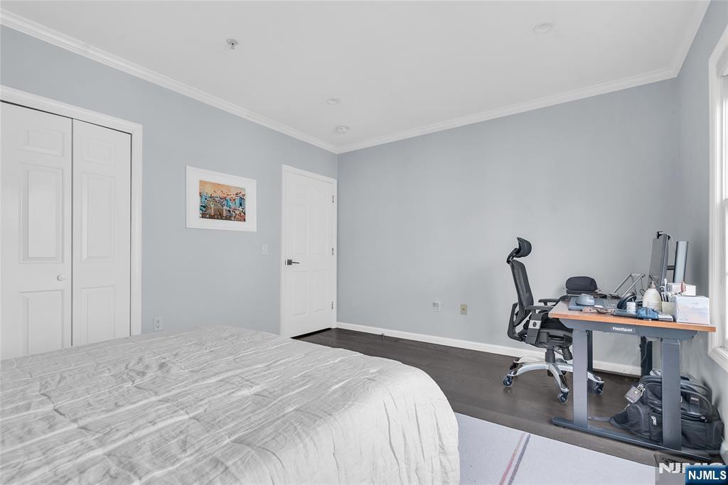314 The Promenade Edgewater, NJ 07020 - Photo 33 of 37 a bedroom with a bed a desk and chair