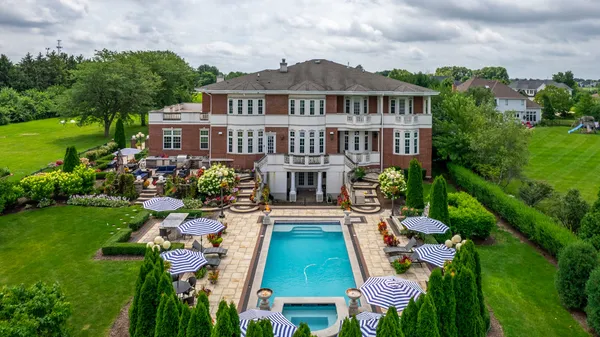 a view of a house with pool and garden