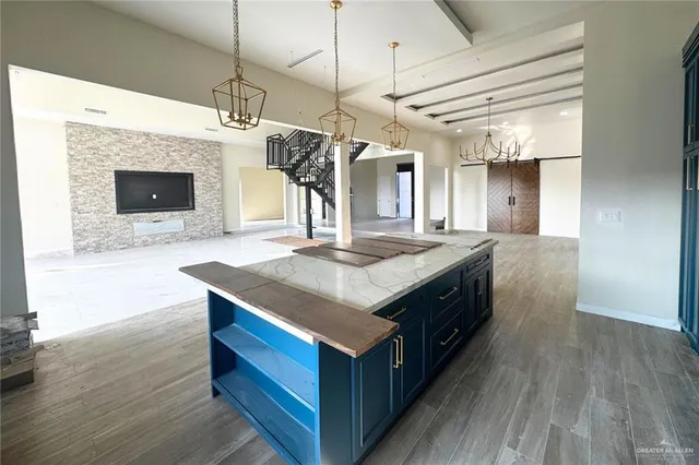 a kitchen with a stove and a wooden floor