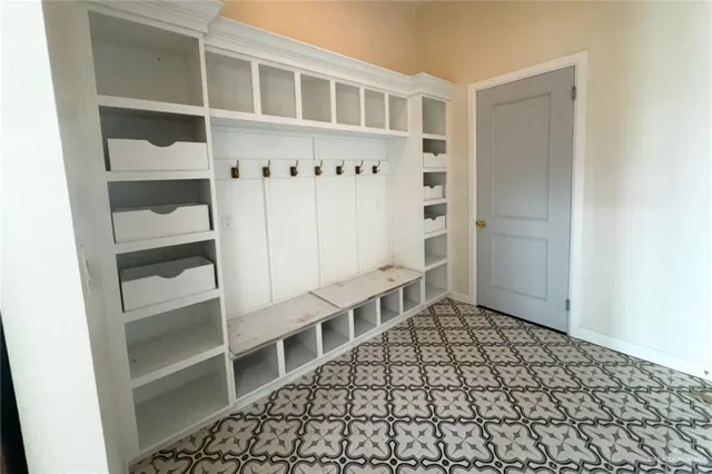a view of a hallway with wooden floor and entryway