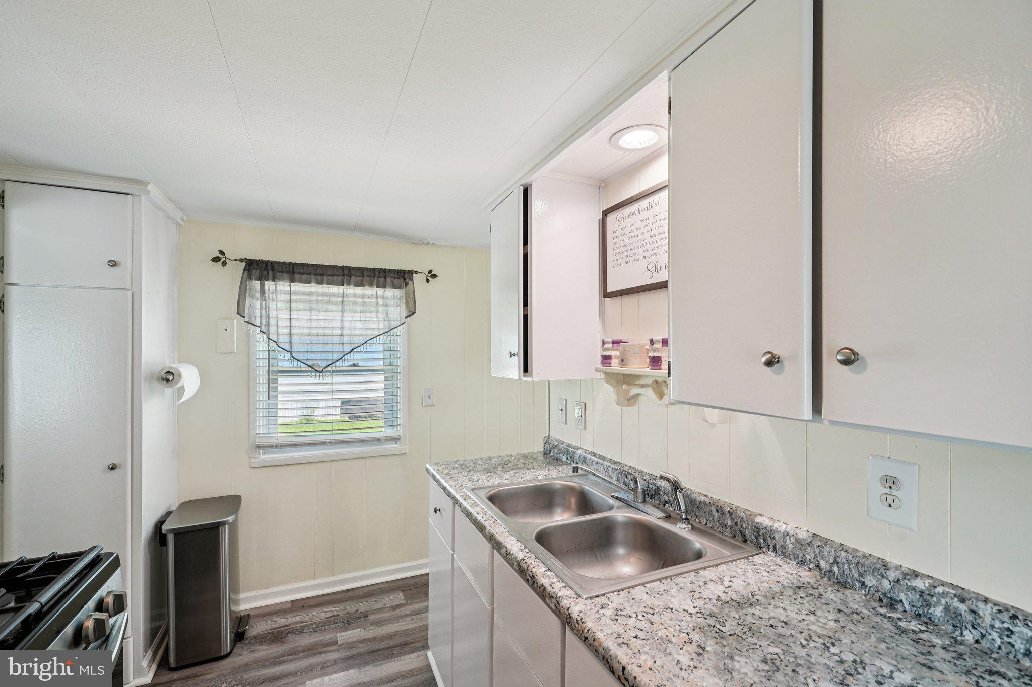 2528 Tilton Road, Unit 421 Egg Harbor Township, NJ 08234 - Photo 14 of 31 a kitchen with granite countertop a sink and a window