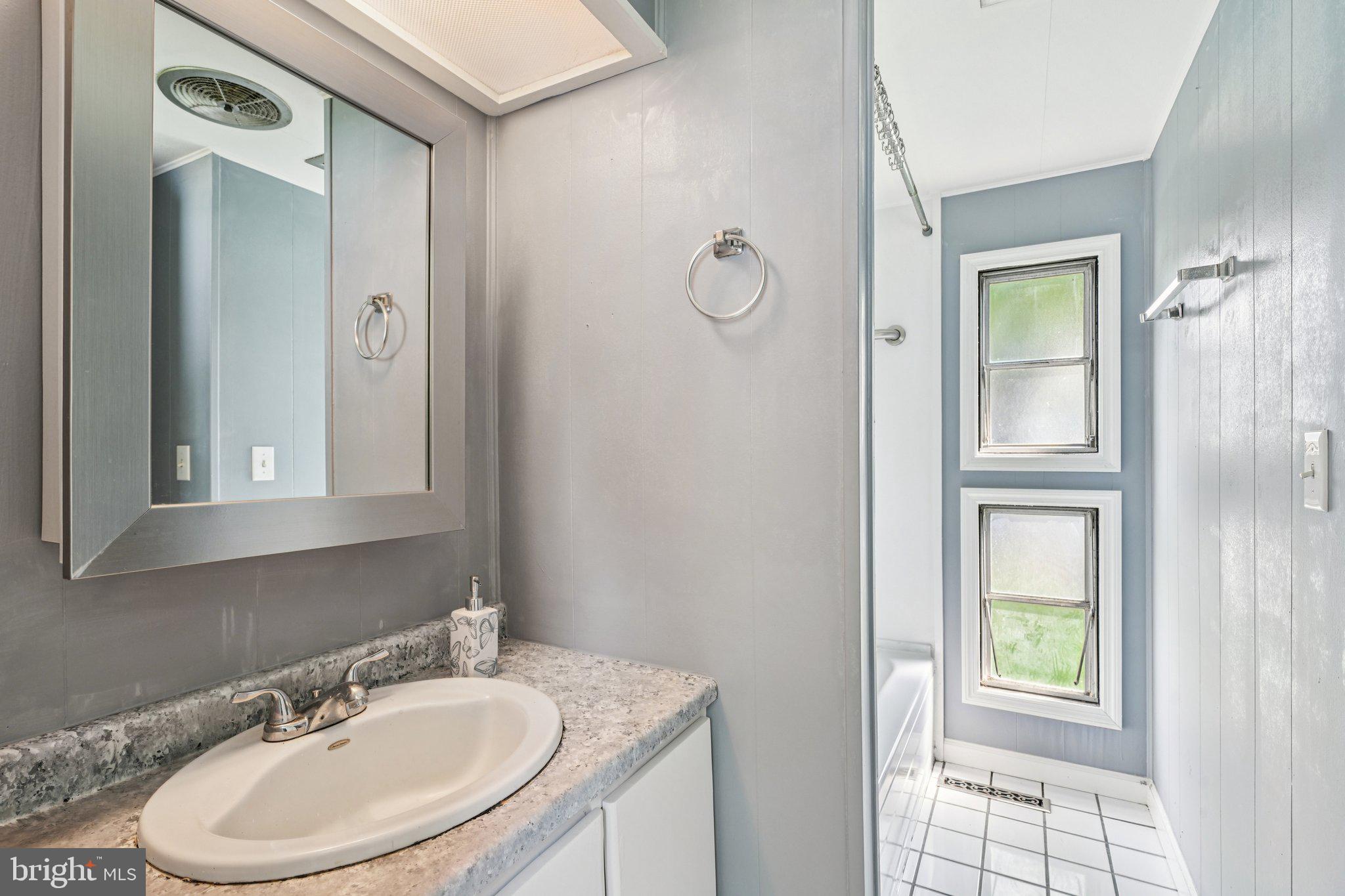2528 Tilton Road, Unit 421 Egg Harbor Township, NJ 08234 - Photo 24 of 31 a bathroom with a sink a toilet and shower