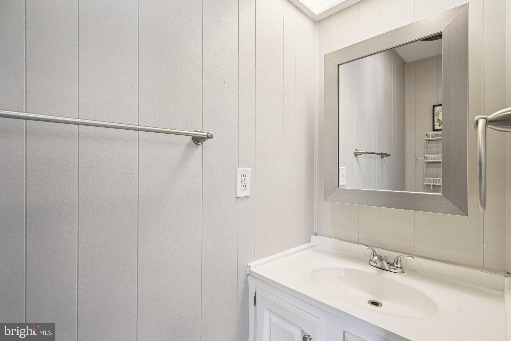 2528 Tilton Road, Unit 421 Egg Harbor Township, NJ 08234 - Photo 27 of 31 a bathroom with a sink a mirror and shower