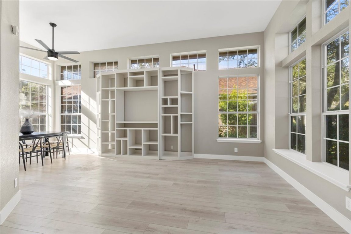 Unfurnished dining area with light wood-style floors and a ceiling fan